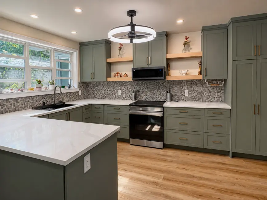 Sage green shaker kitchen with maple floating shelves, a mosaic tile backsplash and a white quartz peninsula counter